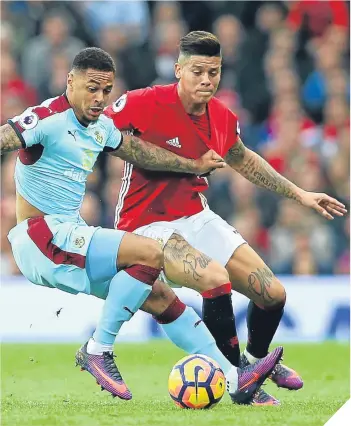  ??  ?? Andre Gray (left) and Marcos Rojo battle for possession at Old Trafford.