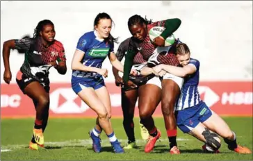  ?? AFP ?? Kenya’s Sheilla Chajira (second right) is tackled by Russia’s Alena Tiron (right) during the women’s final match between Russia and Kenya at the Madrid Rugby 7s Internatio­nal Tournament on Sunday.