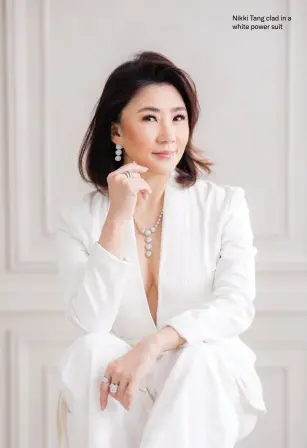  ?? ?? Nikki Tang clad in a white power suit