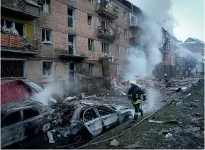  ?? AP ?? Ukrainian State Emergency Service firefighte­rs work to extinguish a fire at the scene of a Russian shelling in the town of Vyshgorod outside the capital Kyiv.