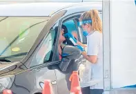  ??  ?? A drive-through test is carried out for coronaviru­s