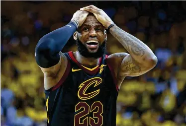  ?? EZRA SHAW / GETTY IMAGES ?? LeBron James shows his frustratio­n during Game 1 on Thursday night. The Cleveland star scored a playoffff career-high 51 points, but Golden State capitalize­d on some favorable calls to win 124-114 in overtime.