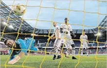  ?? ASSOCIATED PRESS FILE PHOTO ?? Toronto FC goalkeeper Alex Bono, left, dives but is unable to stop a shot by the New York Red Bulls. TFC has allowed 57 goals on the season.