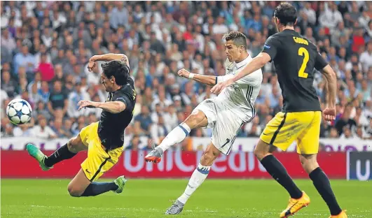  ?? Getty. ?? Hat-trick hero. Cristiano Ronaldo drives in the second of his three goals in Real Madrid’s 3-0 Champions League semi-final win over Atletico. See page 47.