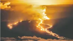  ?? GO NAKAMURA / REUTERS ?? Lava fountains and flows illuminate the area Wednesday
during the Mauna Loa volcano eruption in Hawaii.