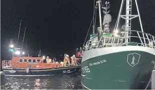  ?? Pictures: Nick Mailer ?? The Grianan Oir is towed back to the safety of Anstruther Harbour with, right, Kieran Fairbairn and crew on an exercise.