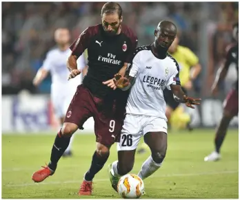  ??  ?? Euro battle...Dudelange’s Jerry Prempeh (right) and Gonzalo Higuain of Milan