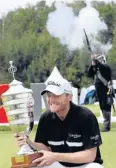  ?? AP ?? Michael Hoey with the trophy as carabineer­s salute his win at the Russian Open.