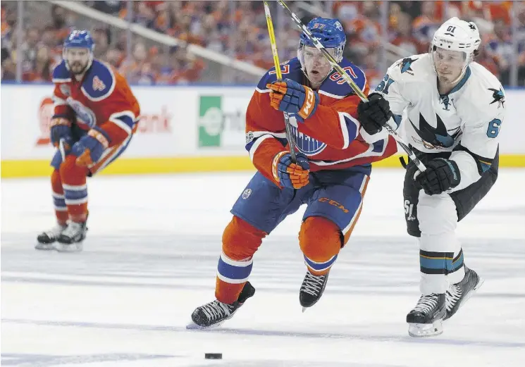  ?? IAN KUCERAK ?? Connor McDavid, seen here battling San Jose’s Justin Braun in Game 1, and the Oilers had a good first stanza, but then the club faltered, losing a 2-0 lead Wednesday night.