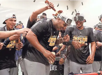  ?? ASSOCIATED PRESS ?? The Brewers’ Jesus Aguilar is doused as he celebrates after the Brewers clinched a postseason berth.