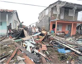  ??  ?? Cubans among the ruins of their homes in Punta Alegre in the wake of Irma