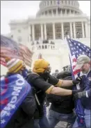  ?? AP file photo ?? Rioters try to break through a police barrier at the Capitol in Washington on Jan. 6.