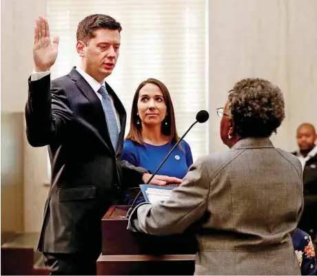  ?? [PHOTO BY STEVE SISNEY, THE OKLAHOMAN] ?? David Holt was sworn in as Oklahoma City’s 36th mayor Tuesday. Holt’s wife, Rachel, held a family Bible for the ceremony. Oklahoma County District 1 Commission­er Willa Johnson administer­ed the oath of office.