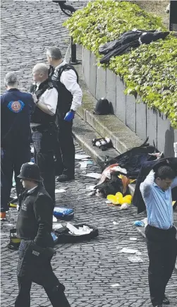  ??  ?? Emergency services outside the Palace of Westminste­r; from left, police gather around the car after it crashed near the Houses of Parliament; a man is treated by paramedics; and a police officer is led away by a colleague. Pictures: PA; AP