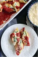  ?? Tribune News Service ?? ■ Jumbo shells stuffed with spinach and mozarella and ricotta cheeses sit in a bed of marinara sauce.
