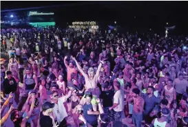  ??  ?? Thousands of partygoers dancing on Haad Rin beach during a Full Moon Party.