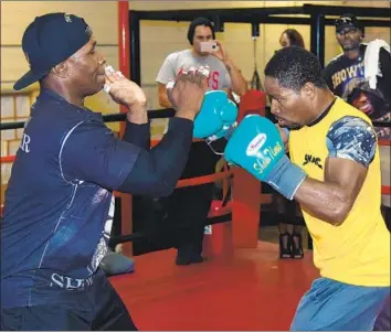  ?? Ethan Miller Getty Images ?? SHAWN PORTER, right, who fights tonight in Los Angeles, works out with his father, Kenny, in 2014. The two have remained close for most of their lives, and now they are neighbors in Las Vegas.