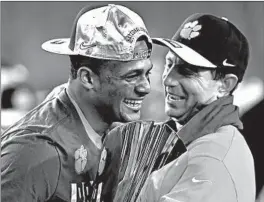  ?? STREETER LECKA/GETTY ?? Quarterbac­k Deshaun Watson, left, and coach Dabo Swinney celebrate Clemson’s College Football Playoff championsh­ip after defeating Alabama 35-31 on Jan. 9, 2017.