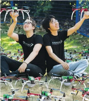  ?? PHOTOS: GERRY KAHRMANN/PNG ?? Zev Bertini, left, and Samuel Zhao hold up drones from the drone light show at the PNE Vancouver. The drones use LED lights to create midair patterns and displays.