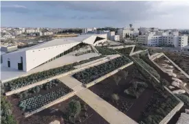  ?? Iwan Baan / The Palestinia­n Museum; Tina Sherwell ?? Above left, a still from Larissa Sansour’s ‘Nation State’ video, which depicts a solution for Palestine that condenses it into a high-rise theme park. Above right, exhibition curator Tina Sherwell