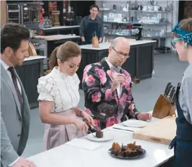  ??  ?? Scott Conant, Marcela Valladolid and Jason Smith check in on Becca Craig in”Best Baker in America”