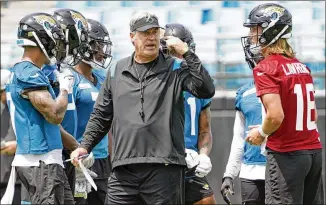  ?? JOHN RAOUX/AP ?? Jaguars’ quarterbac­k Trevor Lawrence (right) calls head coach Doug Pederson’s regime “a more stable environmen­t” and said the distractio­ns they endured last year should help moving forward.
