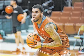  ?? The Associated Press file ?? Texas forward Timmy Allen, formerly at Utah, takes part in drills during a practice at the team’s facility in Austin, Texas.