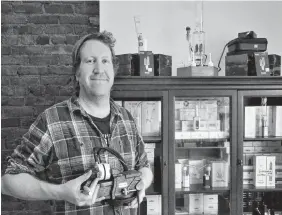  ?? KENN OLIVER THE TELEGRAM ?? Jon Keefe shows off one of the squish presses and other cannabis consumptio­n parapherna­lia he sells at the Dabber Hashery, a specialty shop in downtown St. John’s, N.L. Keefe had initially planned to obtain a licence to sell cannabis products, but abandoned that enterprise when it became clear the eight per cent margin paid to cannabis retailers in Newfoundla­nd and Labrador didn’t make for a strong business case for him and his partners.