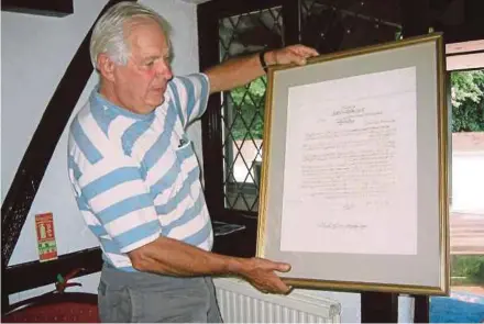  ??  ?? Peter Cox with the farewell letter written in 1875 by community leaders to Sir Andrew Clarke, the Governor of the Straits Settlement­s.