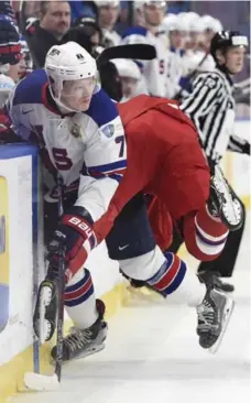  ?? NATHAN DENETTE/THE CANADIAN PRESS ?? U.S. forward Brady Tkachuk, a top prospect for the June NHL draft, slips a check from Radim Salda of the Czech Republic in Friday’s contest.