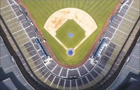  ?? Robert Gauthier Los Angeles Times ?? DODGER STADIUM has been empty of fans, but the players are expected to stage a second spring training there as soon as next week.