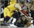  ?? TONY DEJAK — THE ASSOCIATED PRESS ?? The Bucks’ Greg Monroe, bottom, looks to pass under pressure from Kyle Korver during the first half Feb. 27 at Quicken Loans Arena.