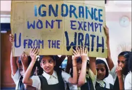  ?? PTI ?? School students display a placard during the global climate strike, in Mumbai, Friday