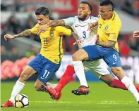  ??  ?? No through road: Brazil’s Philippe Coutinho and Gabriel Jesus combine to halt England’s Ryan Bertrand