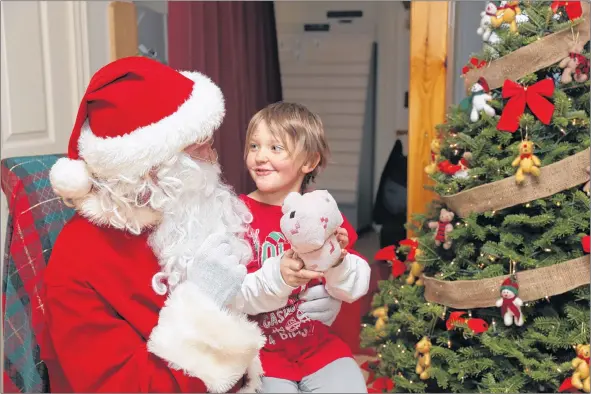  ?? KARLA KELLY ?? Lilly Musizza of New Edinburgh is all smiles as she tells Santa what she would like to have for Christmas during her visit to Sissiboo Landing for the 12th annual Festival of Trees.