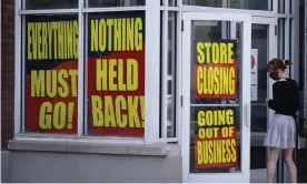  ??  ?? Store closing signs line a window of a business in Salt Lake City. Photograph: Rick Bowmer/AP