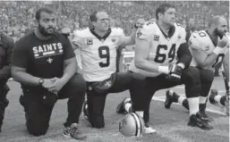  ?? Associated Press file photo ?? New Orleans quarterbac­k Drew Brees kneels down with teammates before America’s national anthem was played ahead of a game against Miami at Wembley Stadium in London on Oct. 1, 2017.