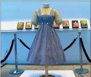  ?? AP PHOTO BY KATIE VASQUEZ ?? A blue and white checked gingham dress, worn by Judy Garland in the “Wizard of Oz,” hangs on display, Monday, April 25, 2022, at Bonhams in New York. One of the most iconic outfits in American movie history is heading for auction, discovered in a box after decades of being thought lost. The dress was found last year at the Catholic University of America, and is on display in New York City before being put up for sale next month by Bonhams.