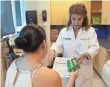  ?? LYNNE SLADKY, AP ?? A nurse give a woman informatio­n on Zika in Miami.