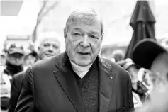  ?? — Reuters photo ?? Pell is surrounded by Australian police as he leaves the Melbourne Magistrate­s Court in Australia.