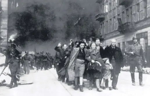  ?? ?? A group of Polish Jews are led away for deportatio­n by German SS soldiers during the destructio­n of the Warsaw Ghetto, Poland, April 19, 1943.