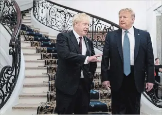  ?? ERIN SCHAFF THE ASSOCIATED PRESS ?? Britain's Prime Minister Boris Johnson and U.S. President Donald Trump arrive for a meeting during the G7 summit on Sunday in Biarritz, France. High on the summit agenda are the climate emergency, the US-China trade war, Britain's departure from the EU, and emergency talks on the Amazon wildfire crisis.