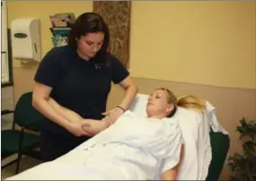  ??  ?? Lymphedema Therapist, Gina Wells, DPT, CLT, demonstrat­es a technique called Manual Lymphatic Drainage.