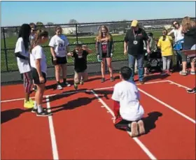  ?? SUBMITTED PHOTO - ETHAN STRAUSE ?? Buddies watching their athlete’s long jump.