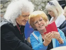  ??  ?? Brian May with a fan