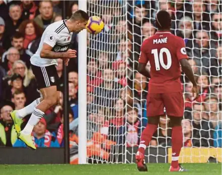  ?? REUTERS PIC ?? Fulham’s Aleksandar Mitrovic (left) scores but is later ruled out for offside in a Premier League match against Liverpool at Anfield on Sunday.