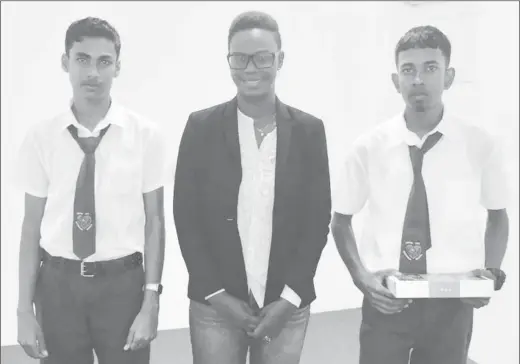  ??  ?? Abram Zuil Secondary School students Ravendra Singh (left) and Renaldo Naraine (right), who placed third and second, respective­ly, in SARA’s anti-corruption essay competitio­n. Standing at centre is the agency’s Chief Administra­tive Officer Mandie Mickle.