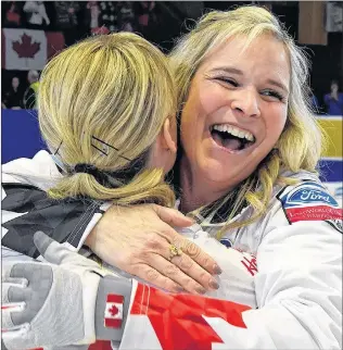  ?? CP PHOTO ?? Canada skip Jennifer Jones hugs third Kaitlyn Lawes as they celebrate their win over against Sweden in the gold medal game at the world women’s curling championsh­ip Sunday in North Bay, Ont.