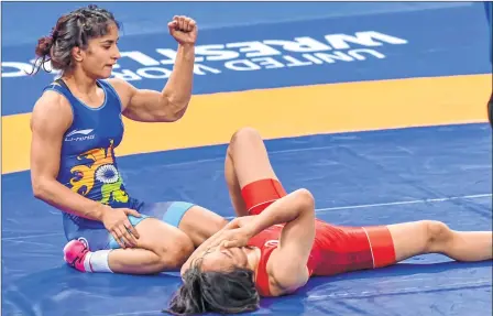  ??  ?? India's Vinesh Phogat rreacts as she celebrates after winning the gold medal in women's freestyle 50 kg wrestling at the Asian Games in Jakarta on Monday