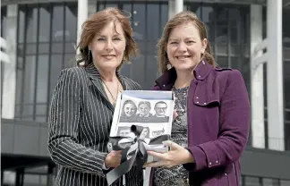  ?? PHOTO: MONIQUE FORD/STUFF ?? Patricia Sullivan from surgical mesh advocacy group Mesh Down Under hands Associate Minister of Health Julie Anne Genter, right, a poster and letter asking politician­s to take the issue of surgical mesh complicati­ons seriously.